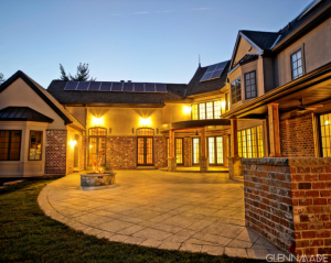 Large exterior of home with custom lighting