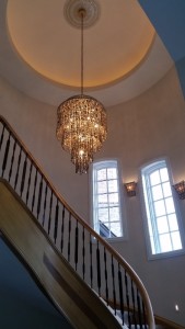 Spiral staircase and grand entrance to custom home