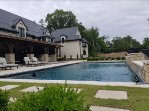 Exterior view of large swimming pool in custom home renovation